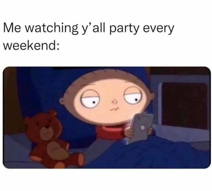 Stewie from Family Guy in bed with a teddy bear, scrolling on a phone, capturing relatable memes about introvert life.