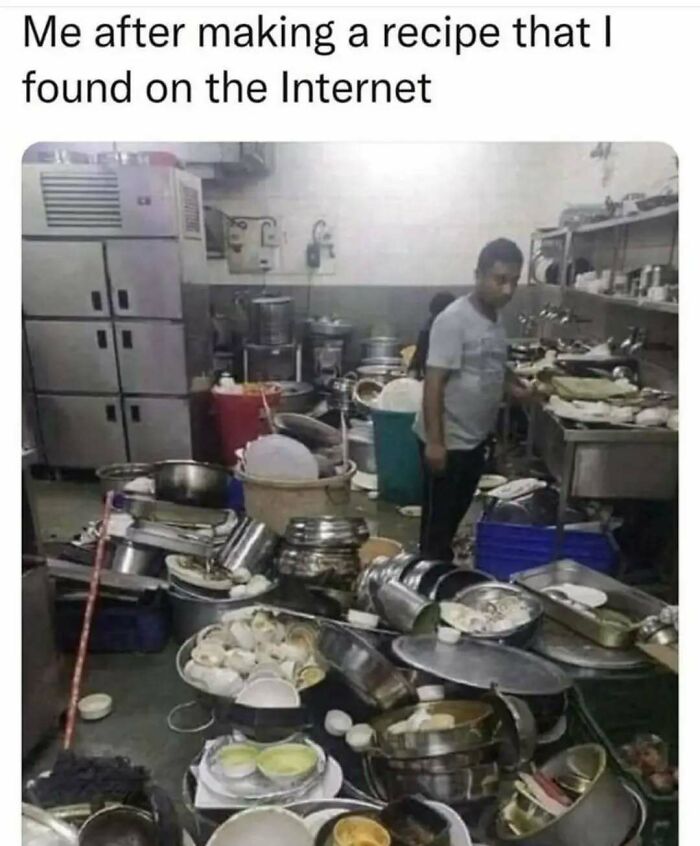 Man standing in a cluttered kitchen with many dirty dishes and pots, illustrating relatable memes about life as an introvert.