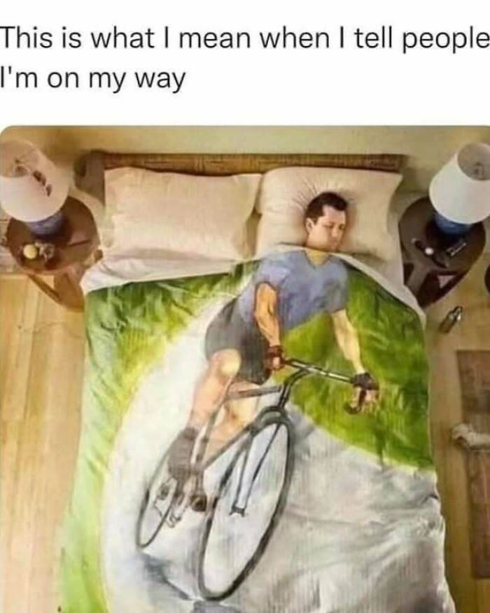 Man lying in bed covered by a blanket showing a cyclist image, illustrating relatable introvert life memes humor.