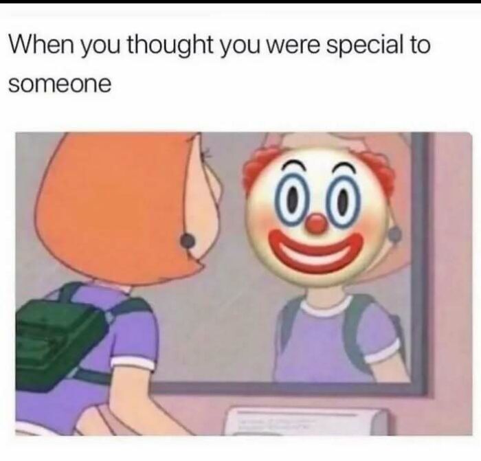 Person with orange hair and backpack looking in mirror, seeing clown face reflection, a relatable meme about introvert life feelings.