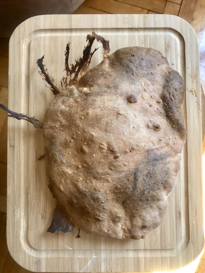 Overcooked and burnt dessert on wooden board showing unexpected dessert ruin mishap.