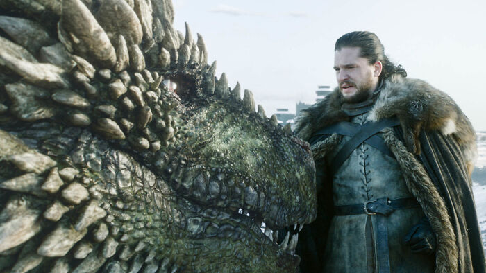 Jon Snow from Game of Thrones standing close to a dragon, highlighting Egg from Knight of the Seven Kingdoms connection