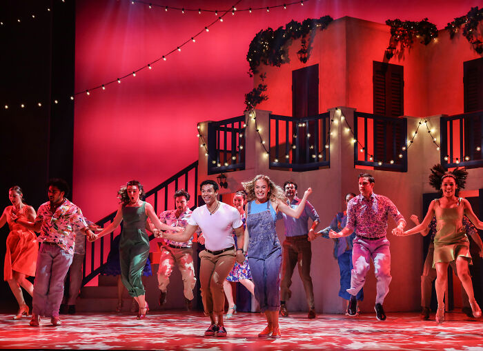 Mamma Mia Broadway cast dancing on vibrant stage; Male Karen incident referenced