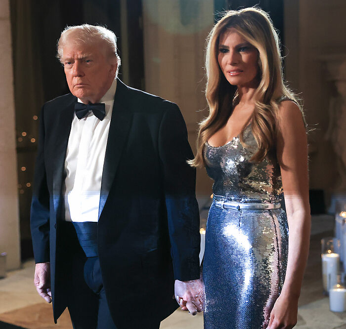 Donald Trump and Melania Trump holding hands at a formal event, linked to Mar-a-Lago rules controversy.