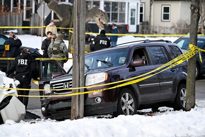 FBI agents examine a crime scene with a crashed SUV and police tape after an incident involving an ICE agent and a slain mom. FBI agents examine a crime scene with a crashed SUV and police tape after an incident involving an ICE agent and a slain mom.