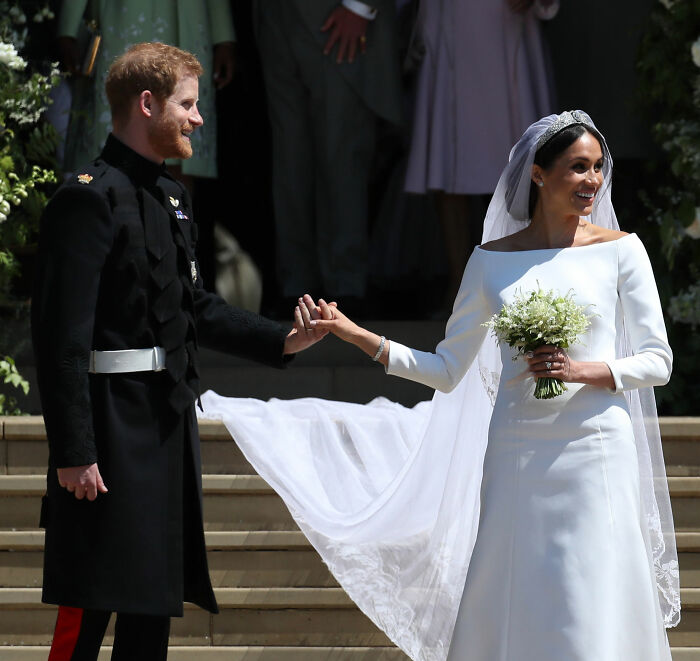 Prince Harry and Meghan Markle holding hands on wedding day, highlighting Meghan Markle's 2016 throwback post controversy.