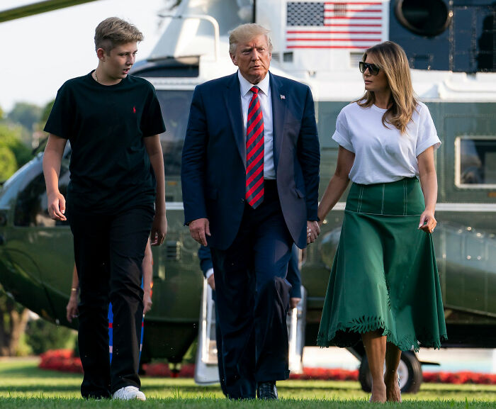 Donald Trump and Melania Trump walking outdoors near a helicopter, related to Mar-a-Lago rules controversy. Donald Trump and Melania Trump walking outdoors near a helicopter, related to Mar-a-Lago rules controversy.