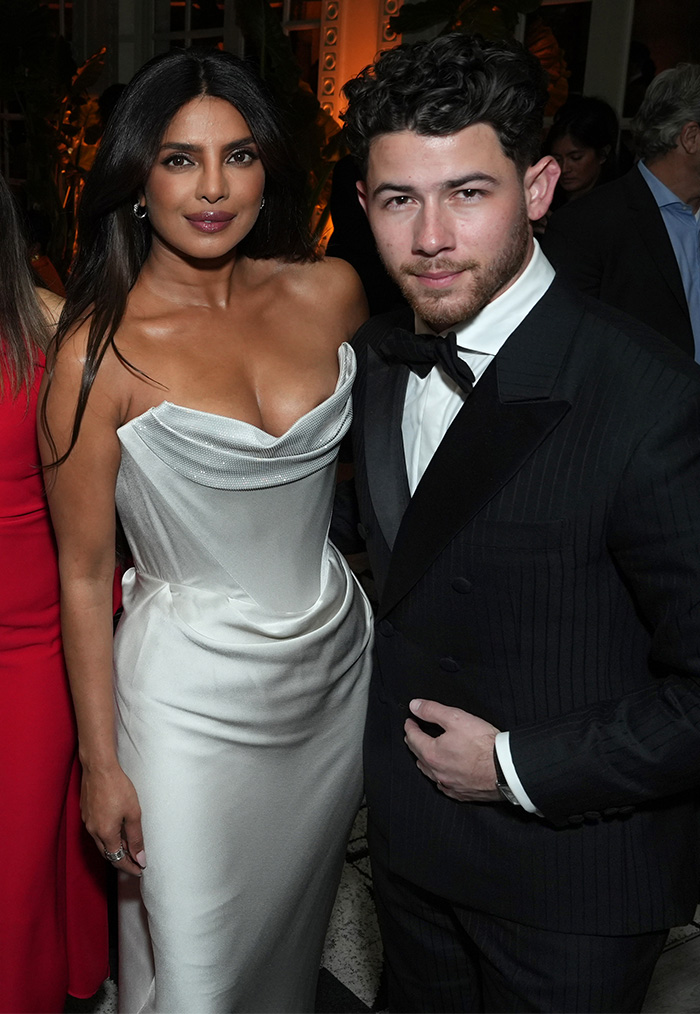 Priyanka Chopra and Nick Jonas posing together wearing formal attire at the worst dressed stars Golden Globes after-parties event