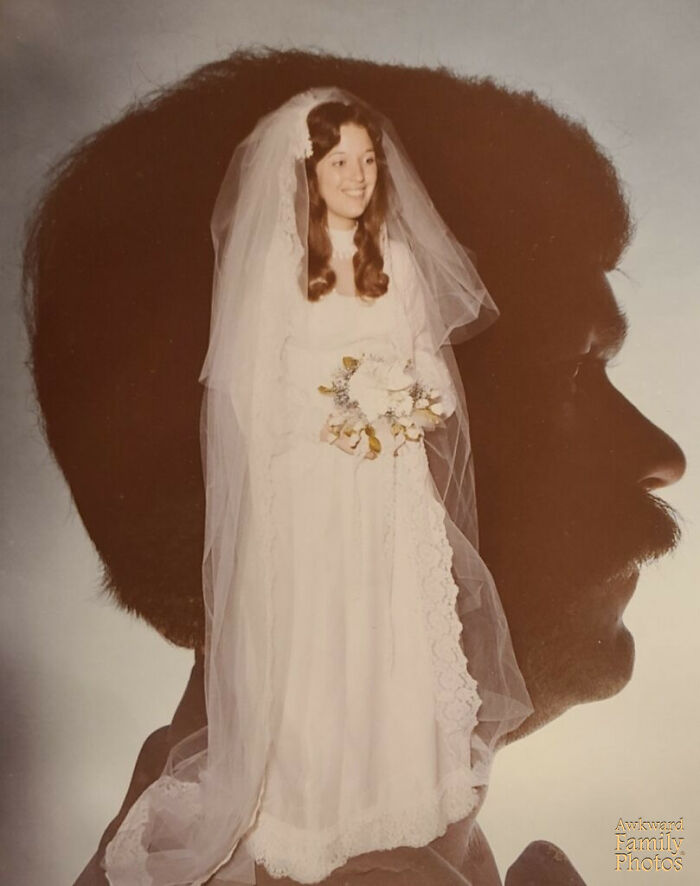 Bride in vintage dress with veil inside silhouette of groom's profile in awkward wedding photo creative double exposure.