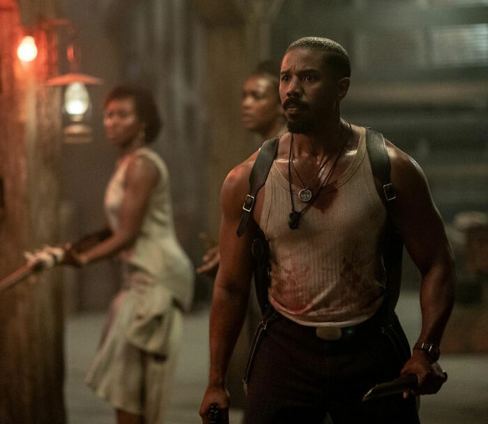 Actor in a tense scene holding a weapon, with two blurred figures behind, representing 2026 Oscar nominations film.