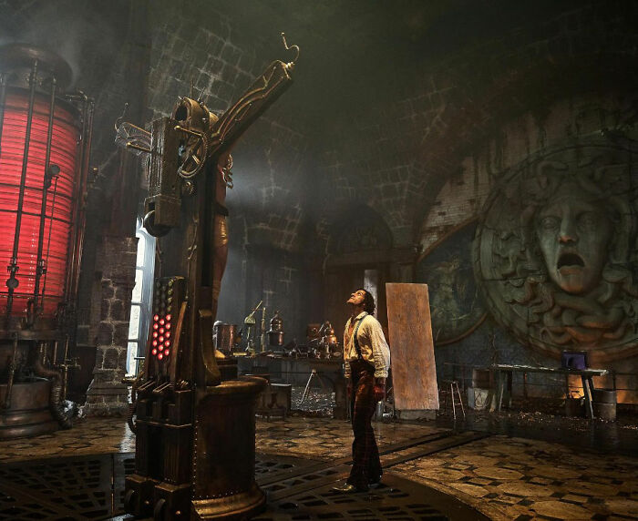 Man in vintage workshop scene with intricate machinery and dramatic lighting, related to Academy 2026 Oscar nominations.