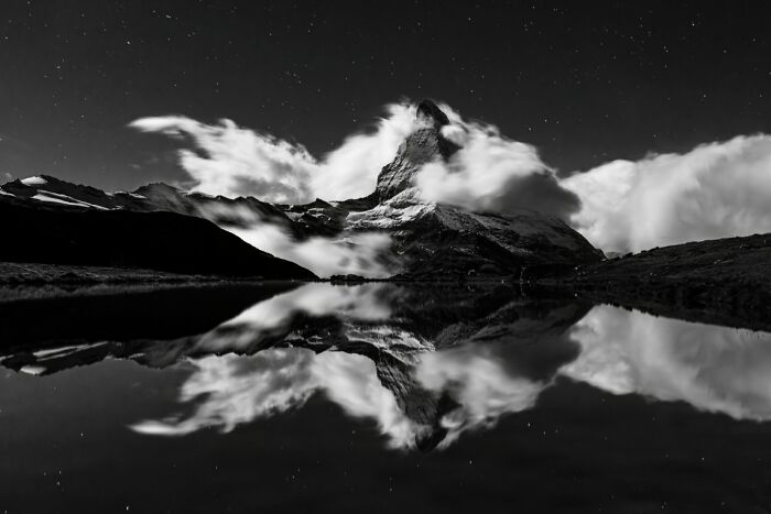 Black and white mountain landscape with clouds and reflection, highlighting stunning animal photos from non professional category.