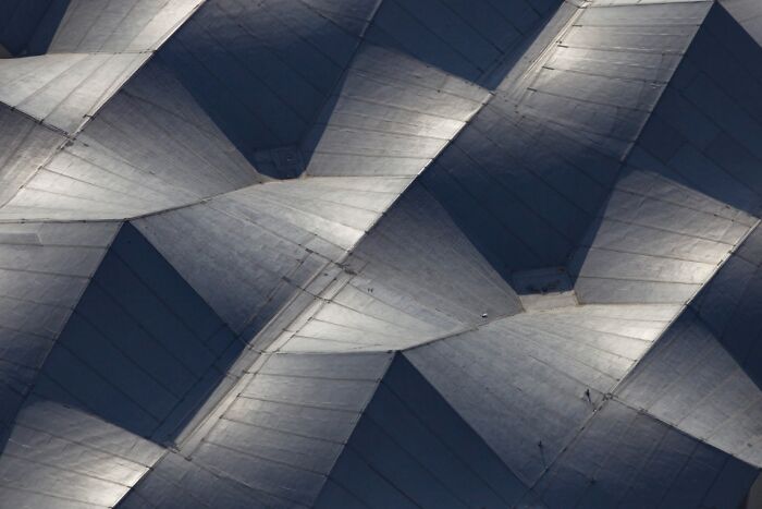 Abstract aerial photo showing geometric patterns and shadows on an architectural surface, from Exposure One Awards.