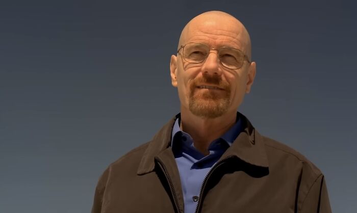 A bald man with glasses and a goatee wearing a brown jacket under clear sky, representing famous villains like Lord Voldemort pure evil.