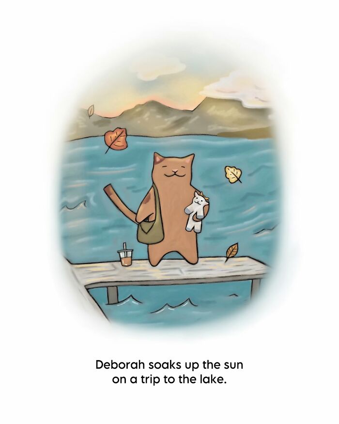 Wholesome cat illustration showing a cozy scene by the lake with a cat holding a small plush toy and fall leaves.