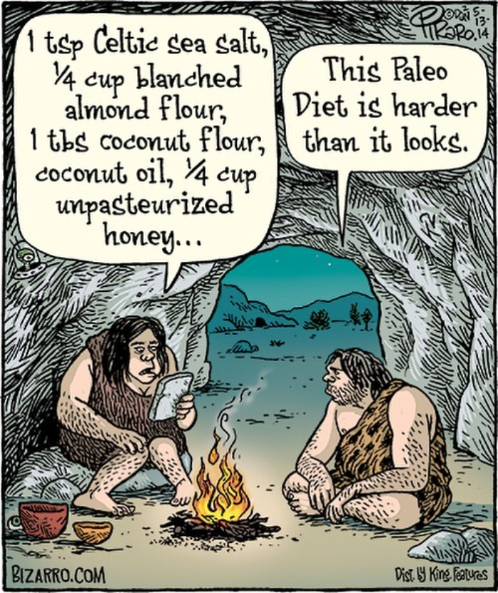 Cartoon by Dan Piraro showing two cavemen discussing the complexity of a Paleo diet recipe by a campfire.