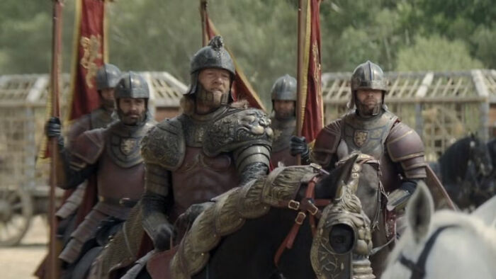 Knights in armor carrying banners featuring house sigils from a fantasy medieval setting in a Knight of the Seven Kingdoms. Knights in armor carrying banners featuring house sigils from a fantasy medieval setting in a Knight of the Seven Kingdoms.