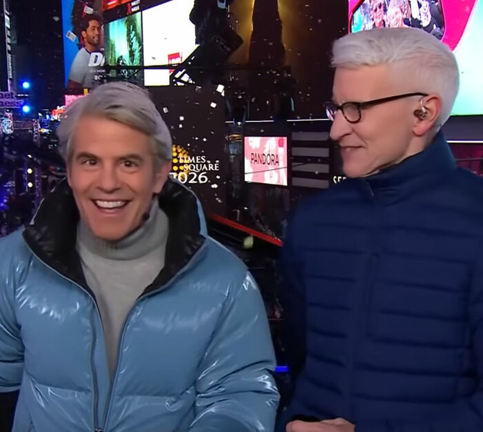 Two hosts in blue jackets during CNN's New Year's Eve broadcast amid Amy Sedaris transphobic jab controversy.