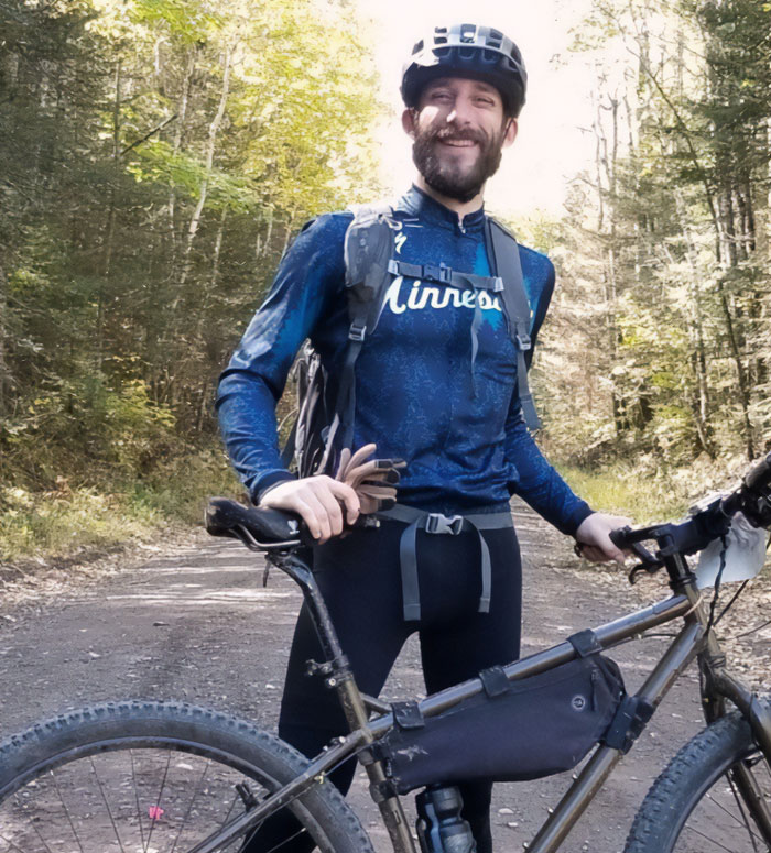 Man with a bike smiling outdoors in forest, representing Alex Pretti’s parents learning his fate from a reporter. Man with a bike smiling outdoors in forest, representing Alex Pretti’s parents learning his fate from a reporter.