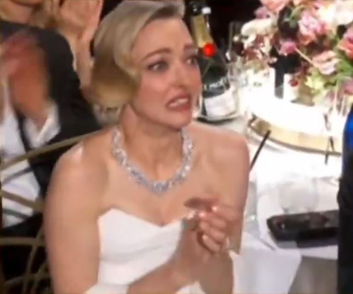 Amanda Seyfried reacting emotionally at the Golden Globes ceremony amid double loss, capturing a terrible loser moment.