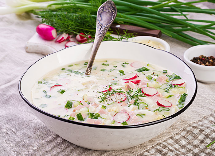 Traditional gross food in a bowl with radishes, cucumbers, and herbs, representing cultural dishes vs American dishes. Traditional gross food in a bowl with radishes, cucumbers, and herbs, representing cultural dishes vs American dishes.