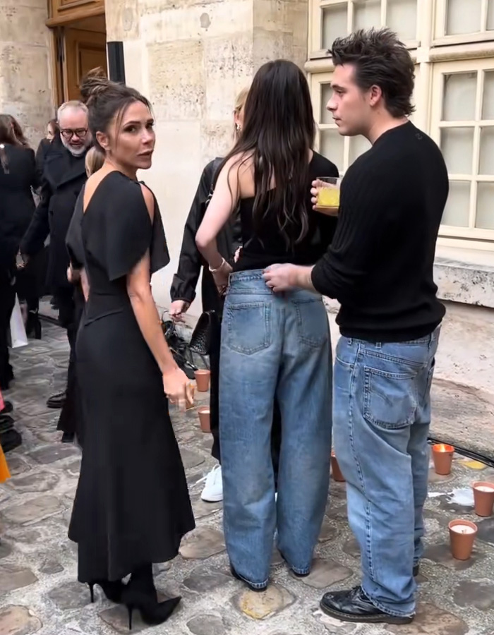 Victoria Beckham in black dress with Nicola Peltz and others in casual outfits during a tense public moment amid feud. Victoria Beckham in black dress with Nicola Peltz and others in casual outfits during a tense public moment amid feud.
