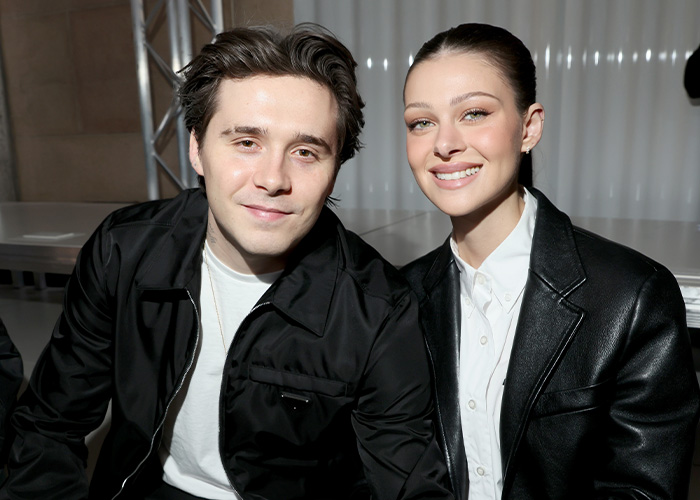 Nicola Peltz and Brooklyn Beckham smiling together at an event, amid Victoria Beckham and Nicola Peltz feud news. Nicola Peltz and Brooklyn Beckham smiling together at an event, amid Victoria Beckham and Nicola Peltz feud news.
