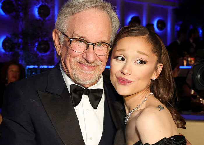 Steven Spielberg and Ariana Grande posing together at the 2026 Golden Globes awkward moments event.