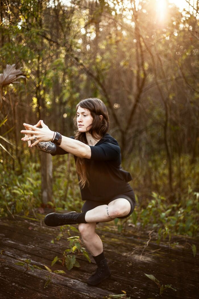 Young woman outdoors balancing on one leg in unusual pose, illustrating weirdest teacher behavior witnessed in class.