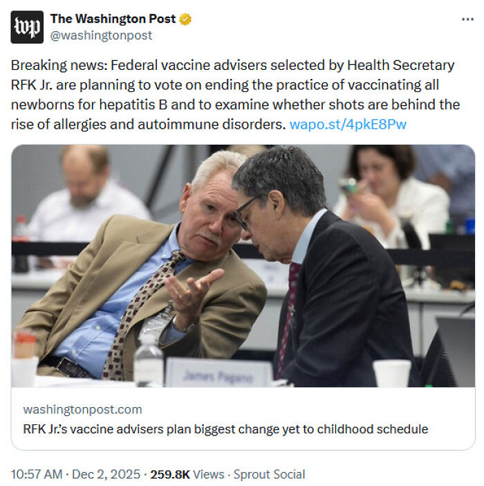 Two men in a formal setting discussing medical knowledge during a vaccine advisory meeting on childhood vaccination changes.