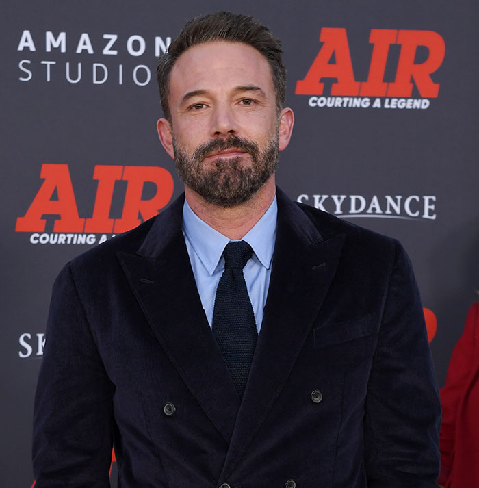 Ben Affleck posing on the red carpet wearing a black suit and tie at the premiere of Air Courting a Legend. Ben Affleck posing on the red carpet wearing a black suit and tie at the premiere of Air Courting a Legend.