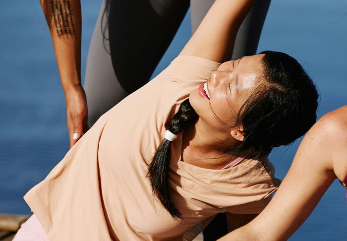 A woman practicing easy skills outdoors with assistance, improving life and working towards retiring rich.