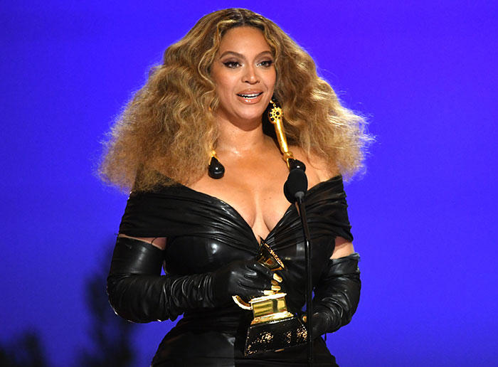 Singer holding a Grammy award on stage, highlighting why Grammy snubs hurt fans more than the artists. Singer holding a Grammy award on stage, highlighting why Grammy snubs hurt fans more than the artists.