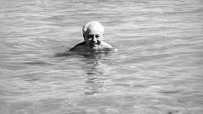 Black and white photo of a man swimming in calm water, representing one of the biggest unsolved cases worldwide.