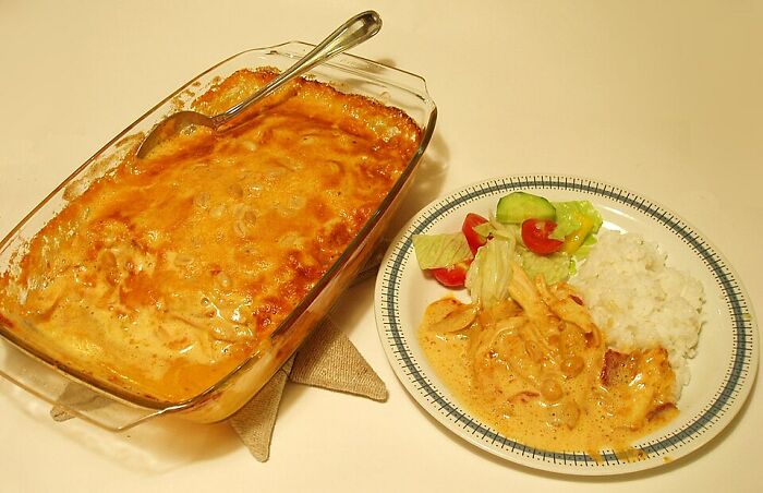 Baked local delicacy served with rice and salad, showcasing one of the disgusting local delicacies from around the world.