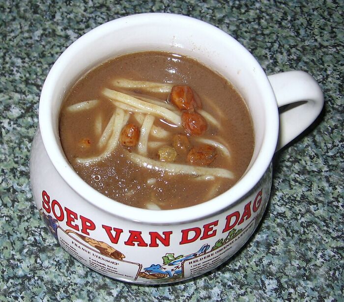Traditional Dutch soup served in a bowl with noodles and beans, representing unusual local delicacies from around the world.