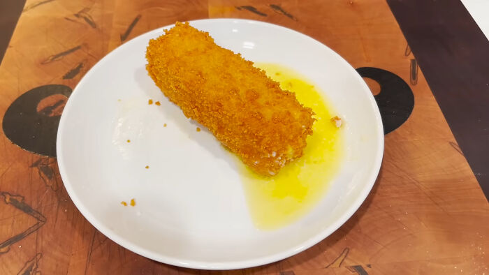 Fried local delicacy on a white plate with oil, illustrating one of the disgusting foods featured in international cuisine.