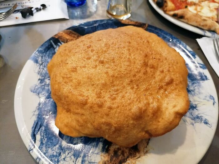 Fried local delicacy on a plate, showcasing one of the most unusual and disgusting local delicacies worldwide.