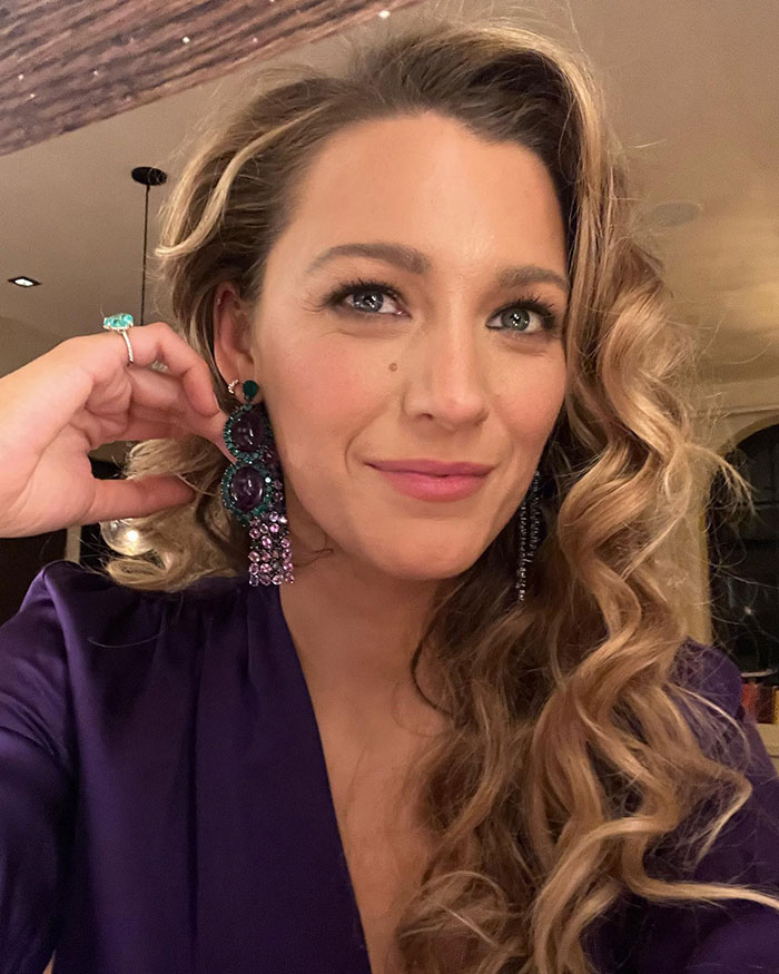 Blake Lively posing indoors wearing purple outfit and statement earrings, related to Ryan Reynolds texts and Justin Baldoni case. Blake Lively posing indoors wearing purple outfit and statement earrings, related to Ryan Reynolds texts and Justin Baldoni case.