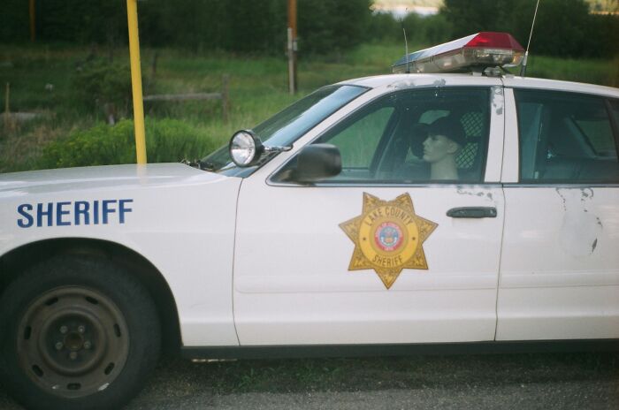 Sheriff car parked near a high school, highlighting times schools faced education challenges and crazy controversies.