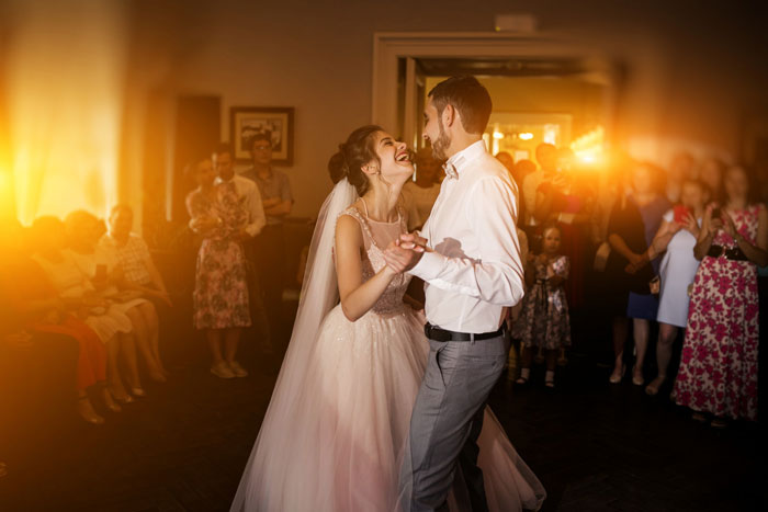 Bride and groom dancing at a wedding reception with guests watching, capturing a moment involving a wedding bridezilla reaction. Bride and groom dancing at a wedding reception with guests watching, capturing a moment involving a wedding bridezilla reaction.