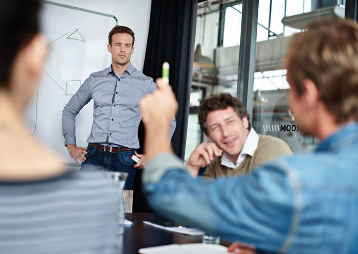 Man presenting a hilarious pitch during a restaurant meeting with business executives after a snarky letter discussion. Man presenting a hilarious pitch during a restaurant meeting with business executives after a snarky letter discussion.