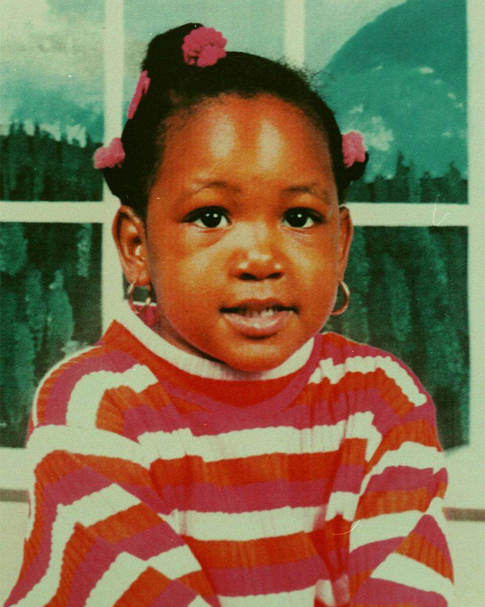 Portrait of a young girl with pink hair ties and hoop earrings, related to five-year-old disappearance in Alligator Alley case.