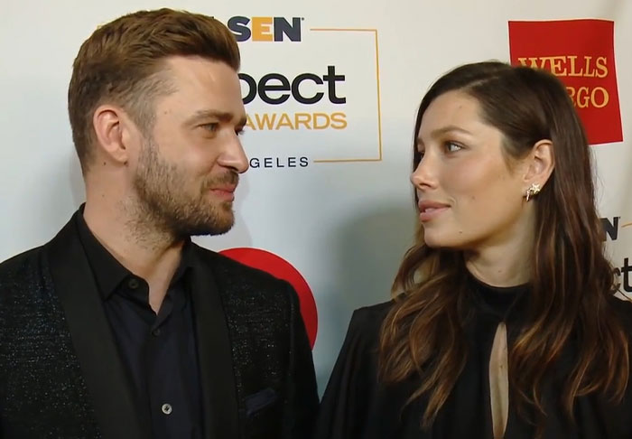 Male and female celebrities looking at each other during an event, illustrating celebrity infidelity scandals theme.