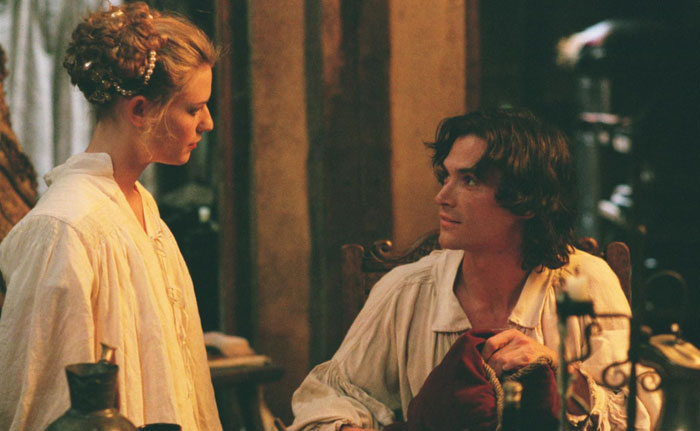 A man and woman in historical costumes having an intense conversation, illustrating celebrity infidelity scandals.