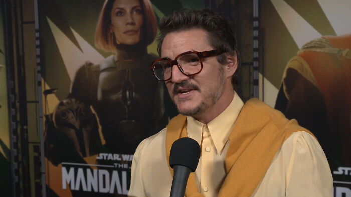 Actor in glasses and yellow outfit giving a savage response during an interview about invasive questions.