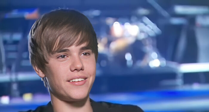 Young male celebrity during an interview, smiling while delivering a savage response to an annoying question.
