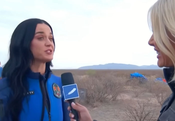 Woman in a blue jacket being interviewed outdoors, illustrating celebrities out of touch with reality moments.