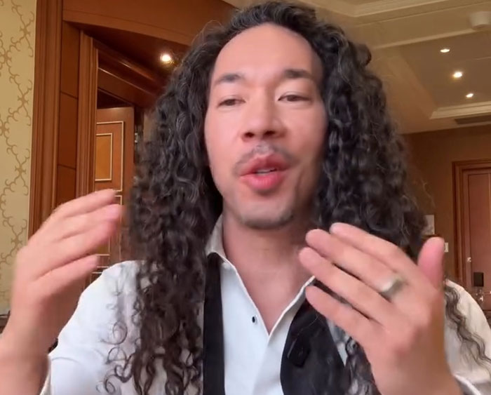 GlamBOT King with long curly hair speaks indoors about viral interaction with Jennifer Lopez at the Golden Globes event.