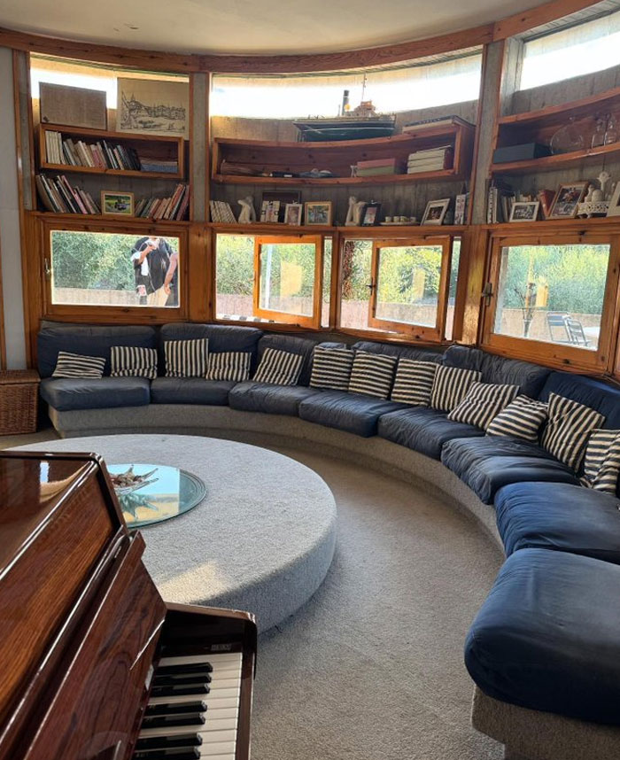 Curved sectional sofa with striped pillows in a bright room showcasing cool interior design ideas and decor accents.